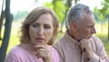 Pensive pensioners thinking of problem, crisis in relations, aged couple divorce