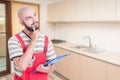 Pensive plumber in the kitchen