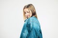 Pensive portrait of a child. little girl in denim jacket posing in the studio. kids fashion. Gray background. portrait