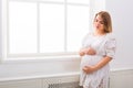 Pensive pregnant woman dreaming about child, copy space. Royalty Free Stock Photo