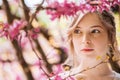 Pensive pretty young woman in spring garden Royalty Free Stock Photo