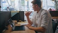 Pensive programmer looking window sitting computer table in morning closeup
