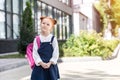 pensive red haired schoolgirl in spectacles wearing backpack