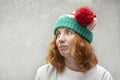 Pensive red-haired woman in elf hat with funny ears. Portrait of side view Royalty Free Stock Photo