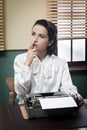 Pensive secretary with typewriter