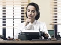 Pensive secretary with typewriter