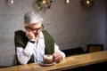 Pensive senior having a coffee in the bar Royalty Free Stock Photo