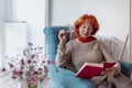 Pensive senior woman reading a book Royalty Free Stock Photo