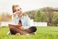 Pensive serious woman sitting outside and writing in her diary Royalty Free Stock Photo