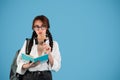 Pensive smart inspired caucasian teen girl with pigtails in glasses with headphones student with backpack