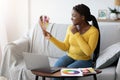 Pensive Smiling Black Lady Looking At Color Swatches At Home, Planning Renovation Royalty Free Stock Photo