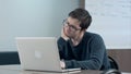 Pensive student with laptop studying in the university library Royalty Free Stock Photo