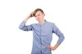 Pensive teenage boy scratching his head thinking, looking confused. has questions isolated over white background Royalty Free Stock Photo