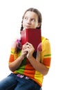 Pensive teenager girl with book