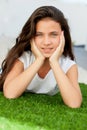 Pensive teenager girl lying on the grass Royalty Free Stock Photo