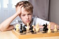 Pensive teenager playing chess