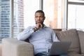 Pensive thoughtful African freelance business man holding laptop on lap Royalty Free Stock Photo