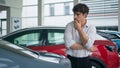 Pensive thoughtful customer Caucasian man client buyer male businessman guy thinking looking at car choosing new modern