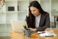 Pensive, Thoughtful, Serious, Ponder young asian businesswoman working on her laptop Royalty Free Stock Photo