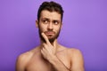 Pensive thoughtful shirtless guy looking aside Royalty Free Stock Photo