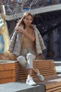 Pensive, thoughtful young woman sitting alone on wooden bench. Sad woman daydreaming, thinking in autumn park. Autumn Royalty Free Stock Photo