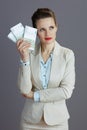 pensive trendy business owner woman in light business suit