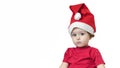 Pensive upset little girl in red suit and santa hat on new year. baby is waiting gift on cristmas. child offended by bad gift