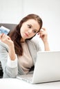 Pensive woman with computer and euro cash money Royalty Free Stock Photo