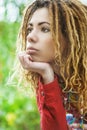 Pensive woman with dreadlocks closeup