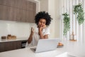 Pensive woman drinking coffee and looking at laptop screen Royalty Free Stock Photo