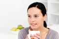 Pensive woman holding a cup of coffee Royalty Free Stock Photo