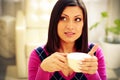 Pensive woman holding cup of coffee Royalty Free Stock Photo