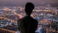 Pensive woman looking at night city from skyscraper Royalty Free Stock Photo