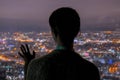 Pensive woman looking at night city from skyscraper Royalty Free Stock Photo