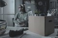 Pensive woman in the office packing her belongings Royalty Free Stock Photo