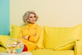 pensive woman in retro clothing with golden fish in aquarium on table at colorful apartment, doll Royalty Free Stock Photo