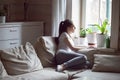 Pensive woman sitting on couch looking at window Royalty Free Stock Photo