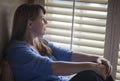 Pensive Woman Sitting Near Window Shades Royalty Free Stock Photo