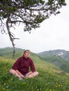 Pensive woman sitting under a branch Royalty Free Stock Photo