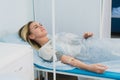 Pensive woman transfused lying in hospital ward