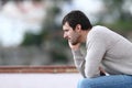 Pensive worried man sitting on a bench