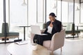 Pensive young African American businesswoman typing on laptop Royalty Free Stock Photo