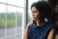 Pensive young african ethnicity woman looking out of window. Royalty Free Stock Photo