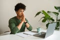 Pensive young black guy freelancer working from cozy cafe Royalty Free Stock Photo