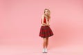 Pensive young blonde woman girl in red sexy clothes isolated on pastel pink wall background studio portrait. People Royalty Free Stock Photo