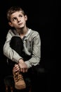 Pensive young boy sitting thinking Royalty Free Stock Photo