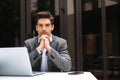 Pensive young businessman dressed in suit working Royalty Free Stock Photo