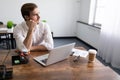 pensive young businessman fills out an insurance form on laptops in the office