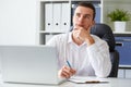 Pensive young businessman with notebook Royalty Free Stock Photo