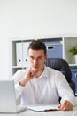 Pensive young businessman with notebook Royalty Free Stock Photo